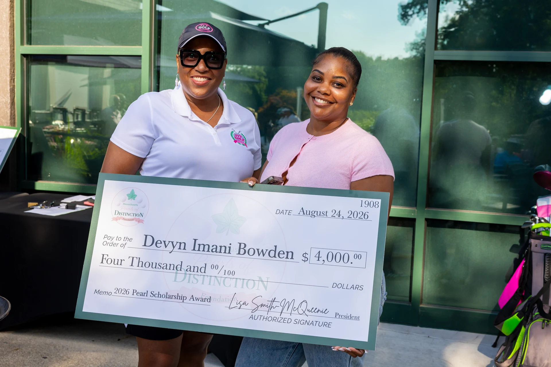 Devyn Bowden’s mother accepts her $4,000 Pearl Scholarship award on her behalf. Devyn had already left for college.